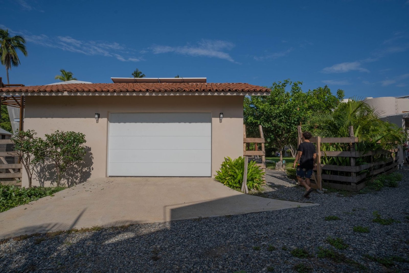 Private garage with automatic door and solar panels on the roof at Casa Nisha