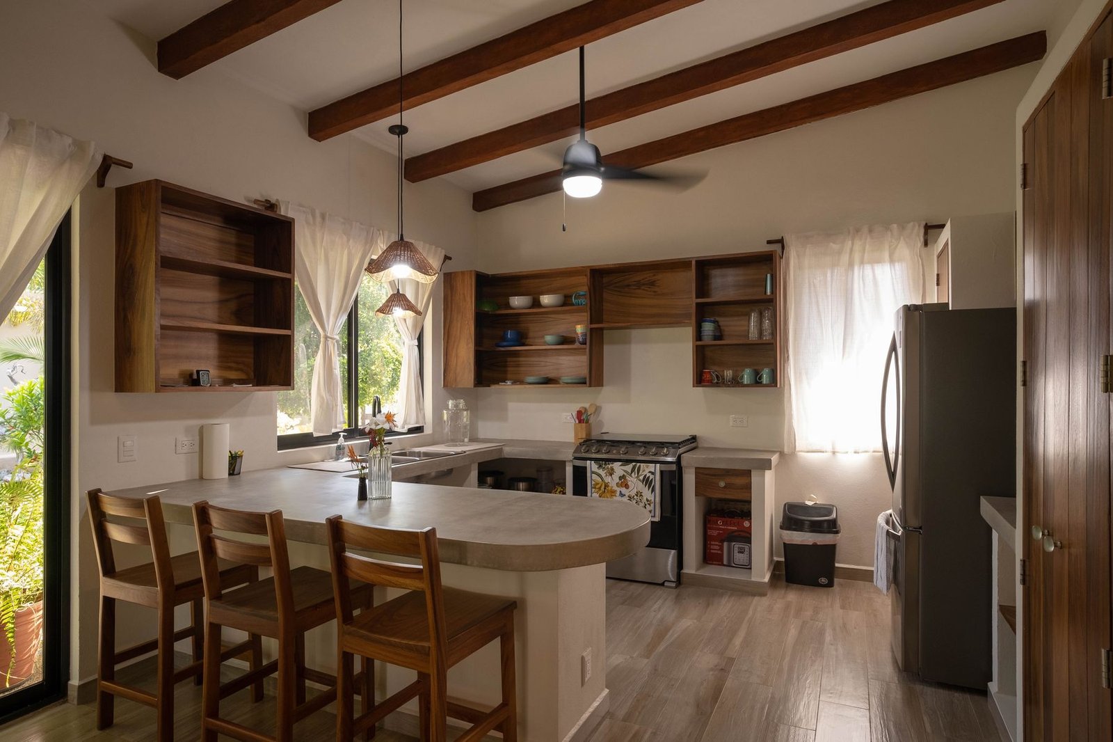 Concrete breakfast bar and open shelving in the Casa Nisha kitchen