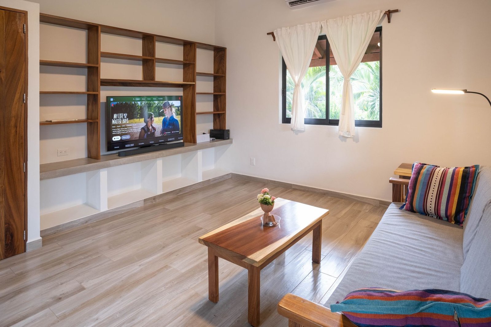 Living room at Casa Nisha with smart TV, built-in shelving and garden window