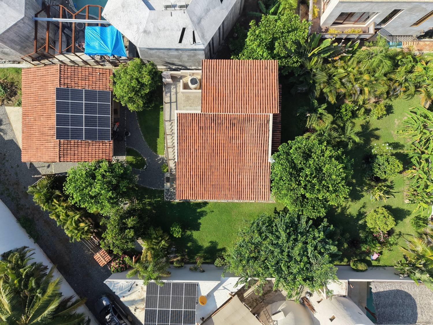 Overhead view of Casa Nisha's terracotta roofs, solar panels and surrounding garden